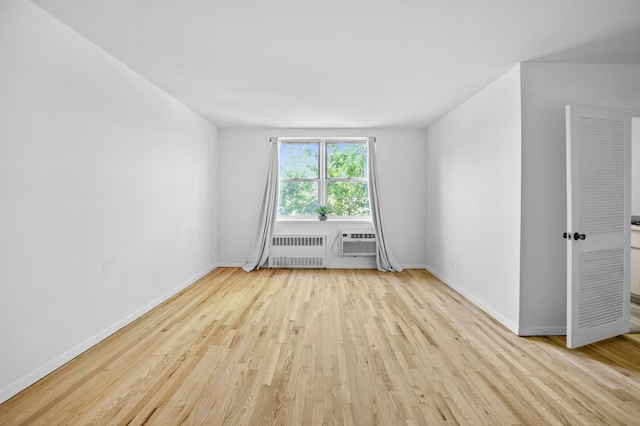 642 Locust St Unit 3K, Mount Vernon, NY 10552 - unfurnished room with radiator heating unit, wood finished floors, baseboards, and a wall mounted AC