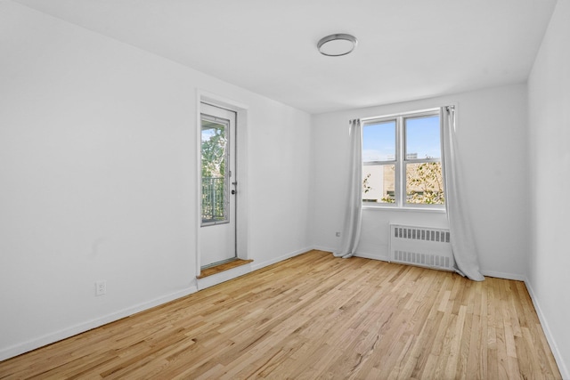 642 Locust St Unit 3K, Mount Vernon, NY 10552 - spare room featuring radiator heating unit, wood finished floors, plenty of natural light, and baseboards