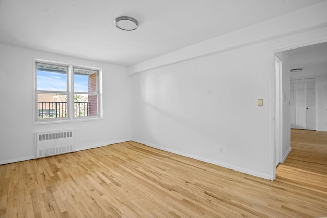 642 Locust St Unit 3K, Mount Vernon, NY 10552 - spare room with radiator, light wood-style floors, and baseboards