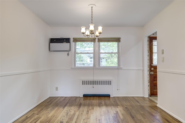 29 Newmarket Rd, Syosset, NY 11791 - unfurnished dining area featuring radiator, a chandelier, wood finished floors, and plenty of natural light