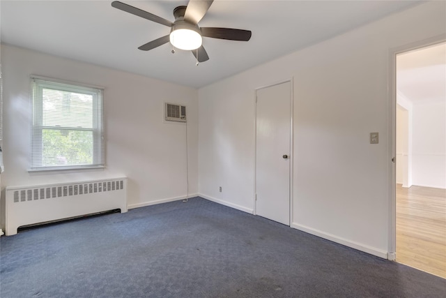 29 Newmarket Rd, Syosset, NY 11791 - empty room with radiator, ceiling fan, dark carpet, and baseboards