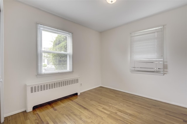 29 Newmarket Rd, Syosset, NY 11791 - spare room with radiator, light wood-style flooring, and baseboards