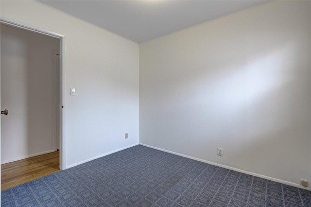 29 Newmarket Rd, Syosset, NY 11791 - unfurnished room with dark carpet and baseboards
