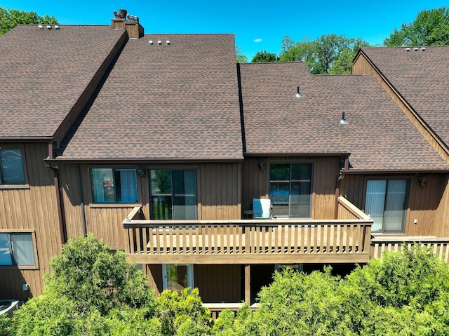 235 Panorama Ct, Poughkeepsie, NY 12603 - back of property with roof with shingles, a chimney, and a deck