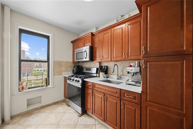 1372 Shakespeare Ave Unit 3A, Bronx, NY 10452 - kitchen featuring stainless steel appliances, light countertops, a sink, decorative backsplash, and brown cabinetry