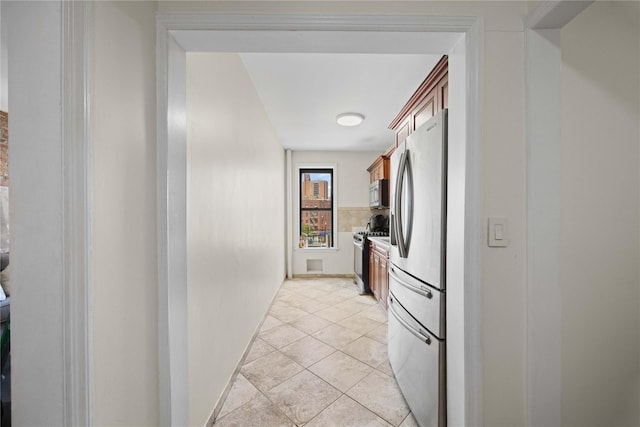 1372 Shakespeare Ave Unit 3A, Bronx, NY 10452 - hallway featuring light tile patterned flooring and baseboards