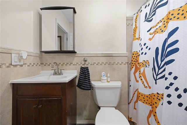 1372 Shakespeare Ave Unit 3A, Bronx, NY 10452 - bathroom featuring tile walls, vanity, toilet, a shower with curtain, and wainscoting
