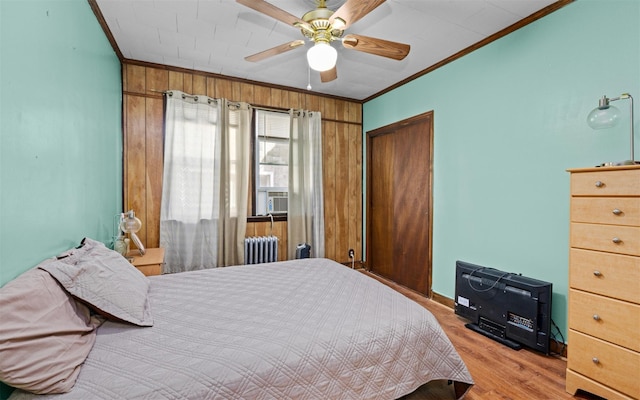 82-60 166th St, Jamaica, NY 11432 - bedroom with radiator heating unit, crown molding, light wood-style floors, a closet, and a ceiling fan