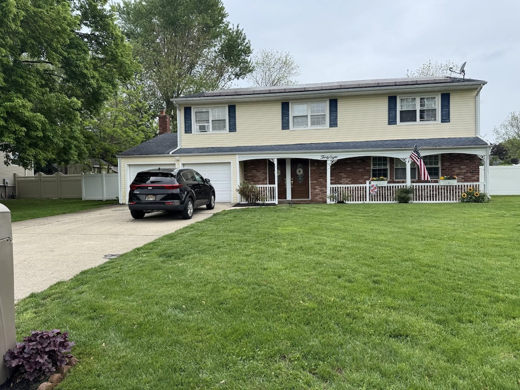 38 Nadine Ln, Port Jefferson Station, NY 11776 - view of front of house with covered porch, concrete driveway, and brick siding