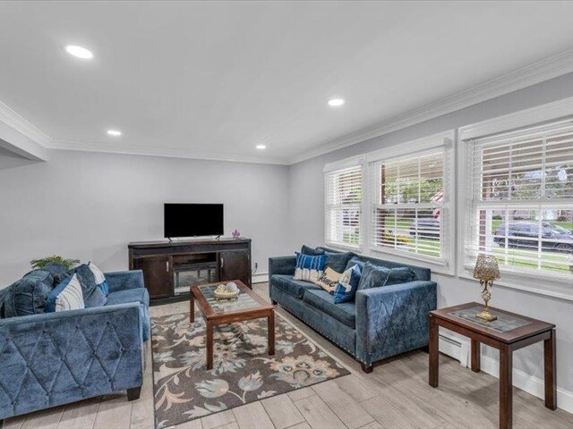 38 Nadine Ln, Port Jefferson Station, NY 11776 - living area featuring recessed lighting, light wood-style floors, baseboards, a baseboard heating unit, and ornamental molding