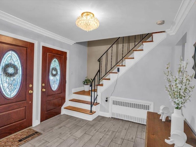 38 Nadine Ln, Port Jefferson Station, NY 11776 - foyer featuring radiator heating unit, stairs, wood finished floors, a chandelier, and baseboards