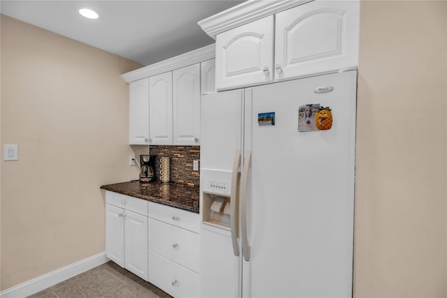38 Nadine Ln, Port Jefferson Station, NY 11776 - kitchen featuring white refrigerator with ice dispenser, baseboards, backsplash, white cabinetry, and dark stone countertops
