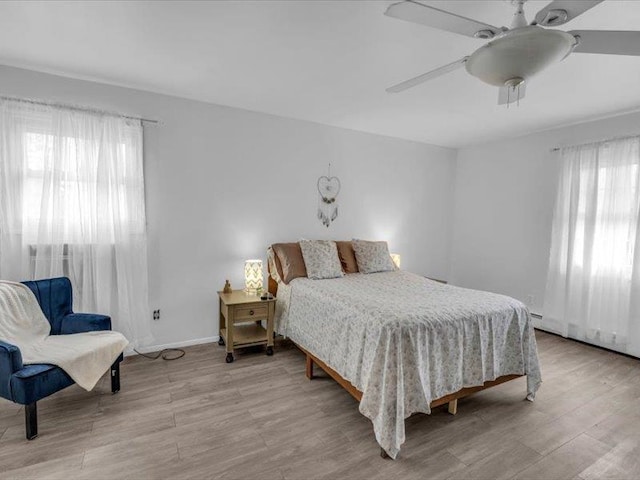 38 Nadine Ln, Port Jefferson Station, NY 11776 - bedroom featuring multiple windows, light wood finished floors, and ceiling fan