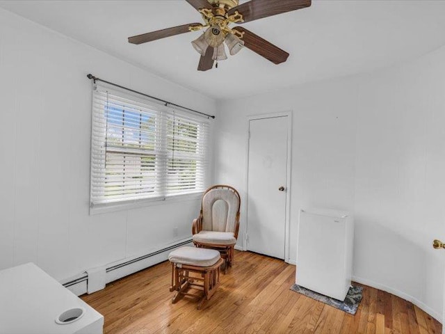 38 Nadine Ln, Port Jefferson Station, NY 11776 - living area with a ceiling fan, light wood-type flooring, and a baseboard heating unit