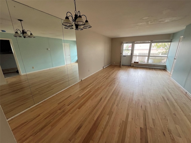 750 Lido Blvd Unit 71A, Lido Beach, NY 11561 - unfurnished living room with a chandelier, wood finished floors, a baseboard radiator, and baseboards