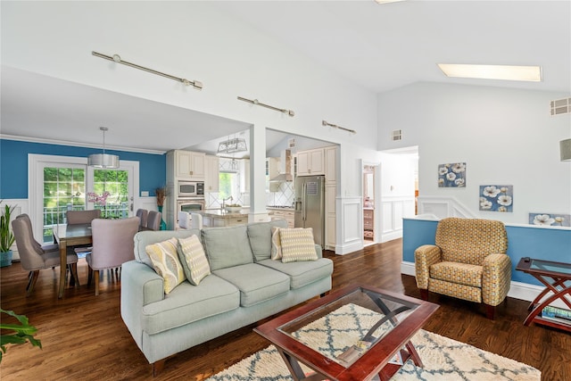 25 Cliff Rd W, Wading River, NY 11792 - living room with dark wood-type flooring, wainscoting, high vaulted ceiling, and track lighting