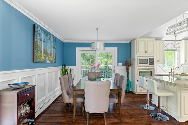 25 Cliff Rd W, Wading River, NY 11792 - dining space featuring a baseboard radiator, a wainscoted wall, healthy amount of natural light, a decorative wall, and crown molding