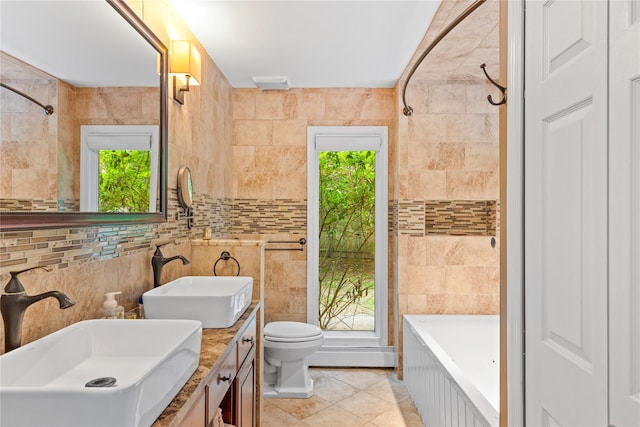 25 Cliff Rd W, Wading River, NY 11792 - full bath featuring tile patterned flooring, healthy amount of natural light, double vanity, toilet, and tile walls