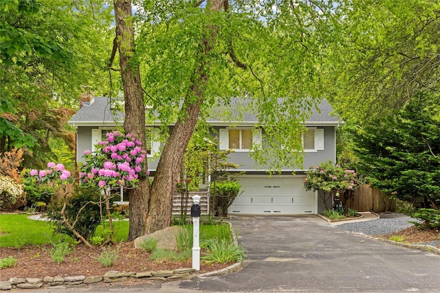 25 Cliff Rd W, Wading River, NY 11792 - view of front facade with driveway, a garage, and a shingled roof
