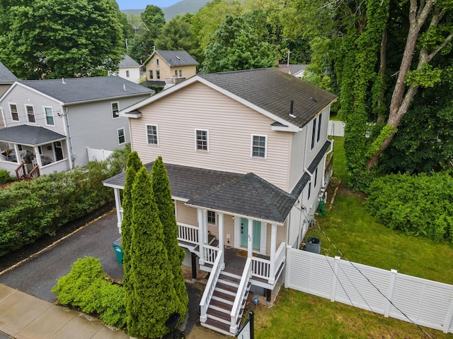 63 Liberty St, Beacon, NY 12508 - view of front of home featuring roof with shingles, a porch, and central AC