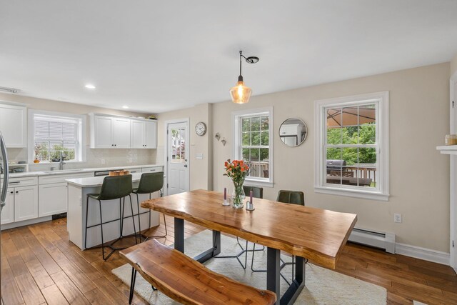 63 Liberty St, Beacon, NY 12508 - dining area featuring baseboard heating, hardwood / wood-style floors, plenty of natural light, recessed lighting, and baseboards