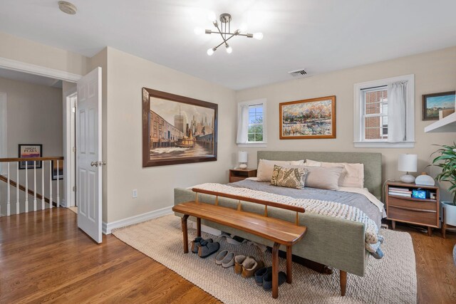 63 Liberty St, Beacon, NY 12508 - bedroom featuring wood finished floors, a chandelier, and baseboards