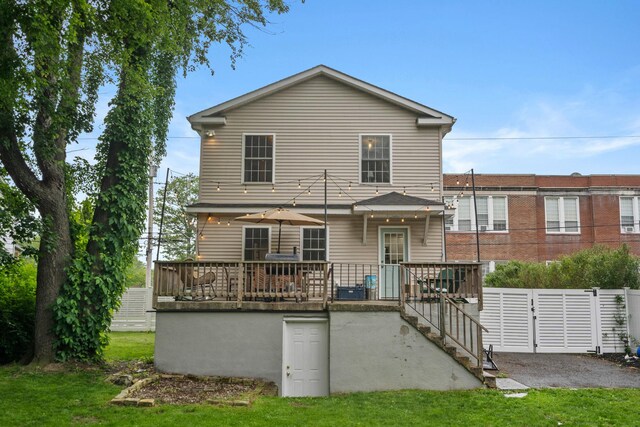 63 Liberty St, Beacon, NY 12508 - back of property featuring a deck, stairway, and a lawn