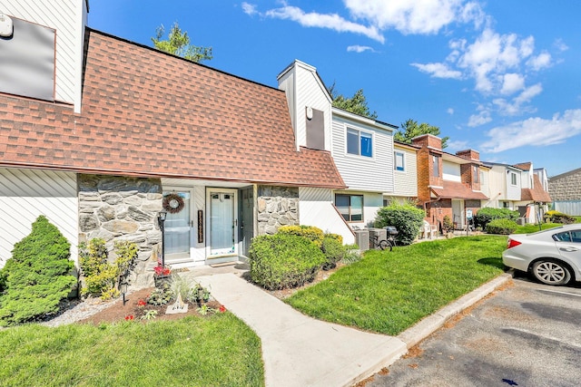 10 Point Cir S Unit 10, Coram, NY 11727 - view of property with a shingled roof, stone siding, and a residential view