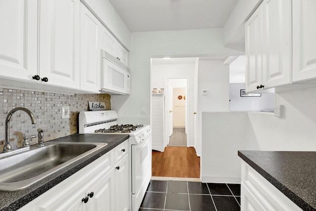 10 Point Cir S Unit 10, Coram, NY 11727 - kitchen with white appliances, a sink, dark tile patterned floors, dark countertops, and white cabinets