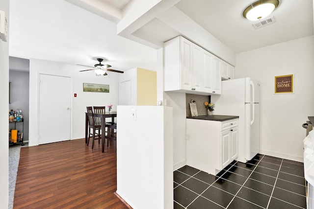 10 Point Cir S Unit 10, Coram, NY 11727 - kitchen featuring freestanding refrigerator, a ceiling fan, white cabinetry, dark countertops, and decorative backsplash