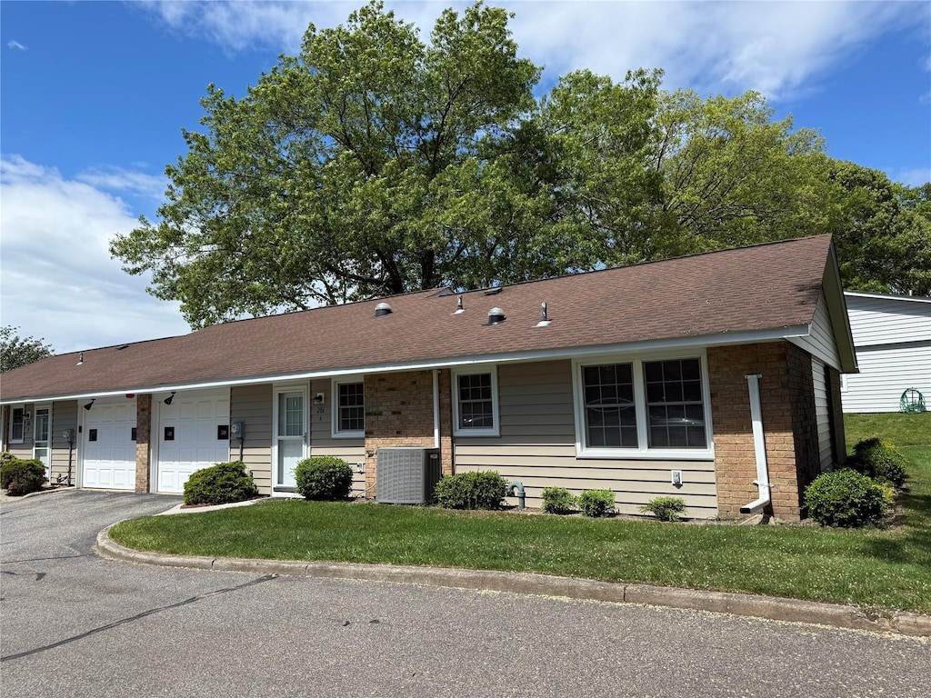 286 Berwick Ct Unit A, Ridge, NY 11961 - single story home with a garage, central AC unit, asphalt driveway, and a front yard