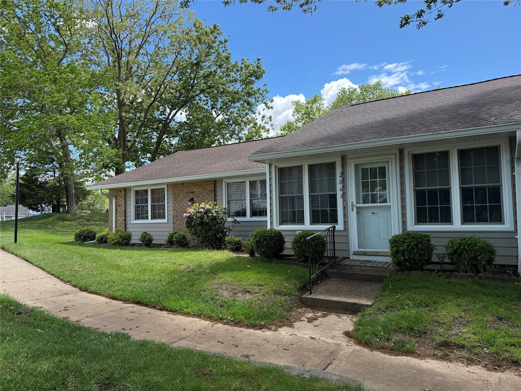 286 Berwick Ct Unit A, Ridge, NY 11961 - view of front facade featuring a front lawn and roof with shingles