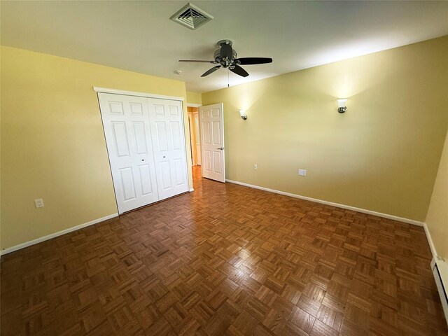286 Berwick Ct Unit A, Ridge, NY 11961 - unfurnished bedroom featuring baseboards, baseboard heating, a closet, and a ceiling fan