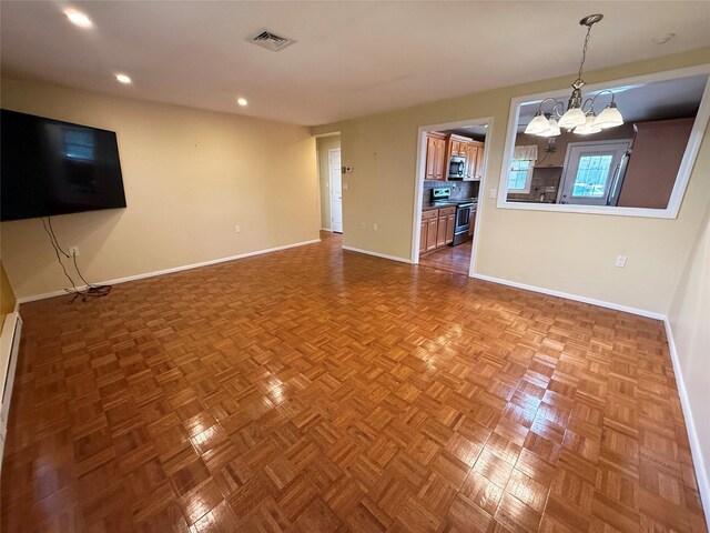 286 Berwick Ct Unit A, Ridge, NY 11961 - unfurnished living room featuring a chandelier, baseboards, and recessed lighting