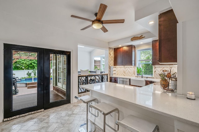 29 Montauk St, Selden, NY 11784 - kitchen featuring french doors, dishwasher, tasteful backsplash, a sink, and stone tile floors
