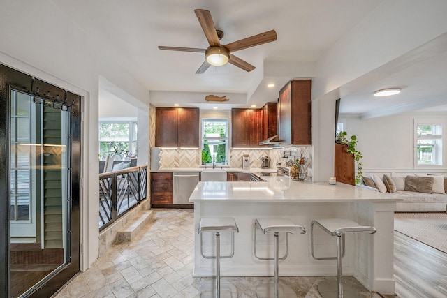 29 Montauk St, Selden, NY 11784 - kitchen with decorative backsplash, appliances with stainless steel finishes, light countertops, a kitchen bar, and a peninsula