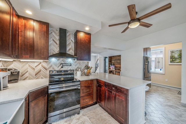 29 Montauk St, Selden, NY 11784 - kitchen with stainless steel appliances, wall chimney range hood, a peninsula, a baseboard heating unit, and light countertops