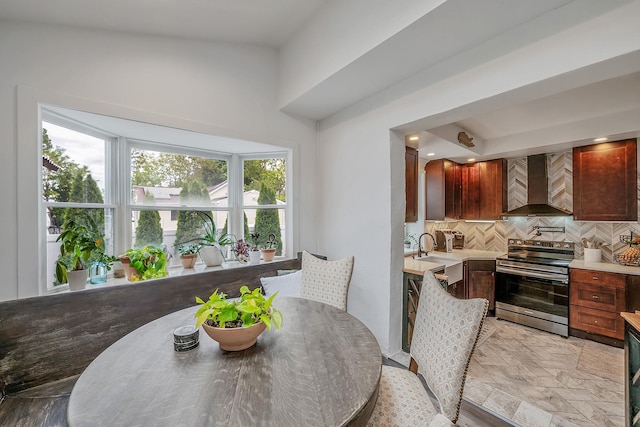 29 Montauk St, Selden, NY 11784 - kitchen with stainless steel electric range, wall chimney exhaust hood, tasteful backsplash, and light countertops