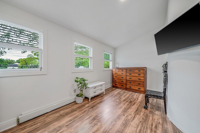 29 Montauk St, Selden, NY 11784 - bedroom featuring a baseboard heating unit, light wood-type flooring, lofted ceiling, and baseboards
