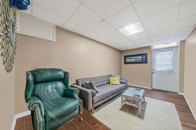 29 Montauk St, Selden, NY 11784 - living area with wood finished floors, baseboards, and a drop ceiling