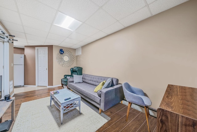 29 Montauk St, Selden, NY 11784 - living area featuring wood finished floors, a drop ceiling, and baseboards