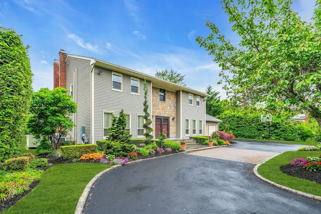 8 Victor Ln, Woodbury, NY 11797 - view of front of property featuring a chimney, stone siding, and a garage
