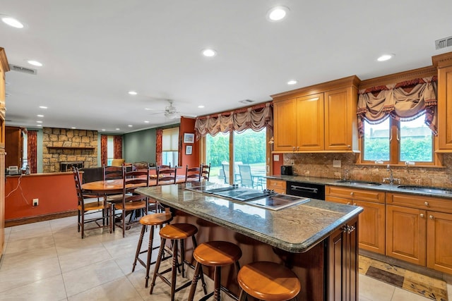 8 Victor Ln, Woodbury, NY 11797 - kitchen featuring stovetop with downdraft, a ceiling fan, a center island, light tile patterned flooring, and plenty of natural light
