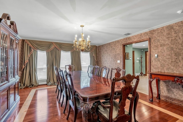 8 Victor Ln, Woodbury, NY 11797 - dining space with wallpapered walls, hardwood / wood-style flooring, a chandelier, and ornamental molding