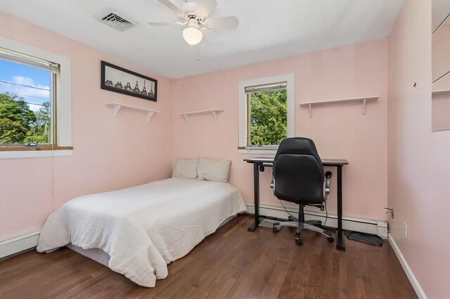 312 Diddell Rd, Poughkeepsie, NY 12603 - bedroom featuring wood finished floors, multiple windows, and a baseboard heating unit
