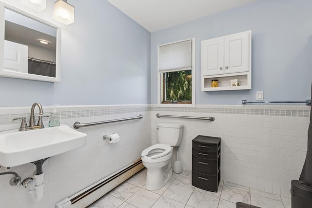 312 Diddell Rd, Poughkeepsie, NY 12603 - bathroom with a baseboard radiator, toilet, marble look tiles, tile walls, and a wainscoted wall