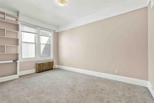3004 14th St, Astoria, NY 11102 - carpeted empty room featuring radiator heating unit and baseboards