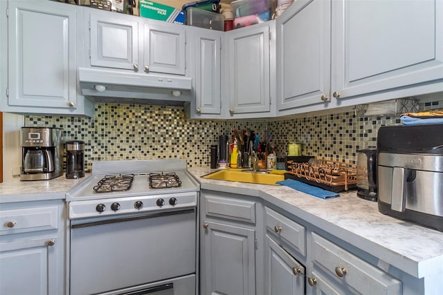 4 Oakley Pl, Mount Vernon, NY 10550 - kitchen featuring gas range gas stove, under cabinet range hood, light countertops, decorative backsplash, and gray cabinets