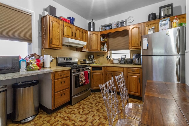 4 Oakley Pl, Mount Vernon, NY 10550 - kitchen featuring appliances with stainless steel finishes, under cabinet range hood, healthy amount of natural light, and open shelves