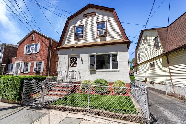 4 Oakley Pl, Mount Vernon, NY 10550 - dutch colonial with a gambrel roof, a gate, a fenced front yard, cooling unit, and stucco siding